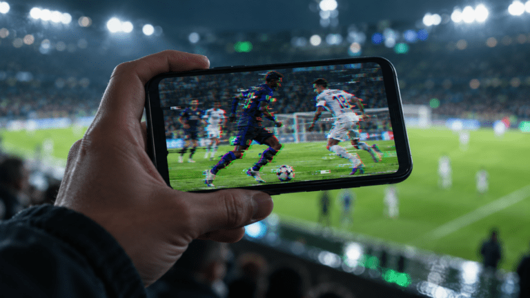 Paused football video showing digital artifacts on a smartphone screen